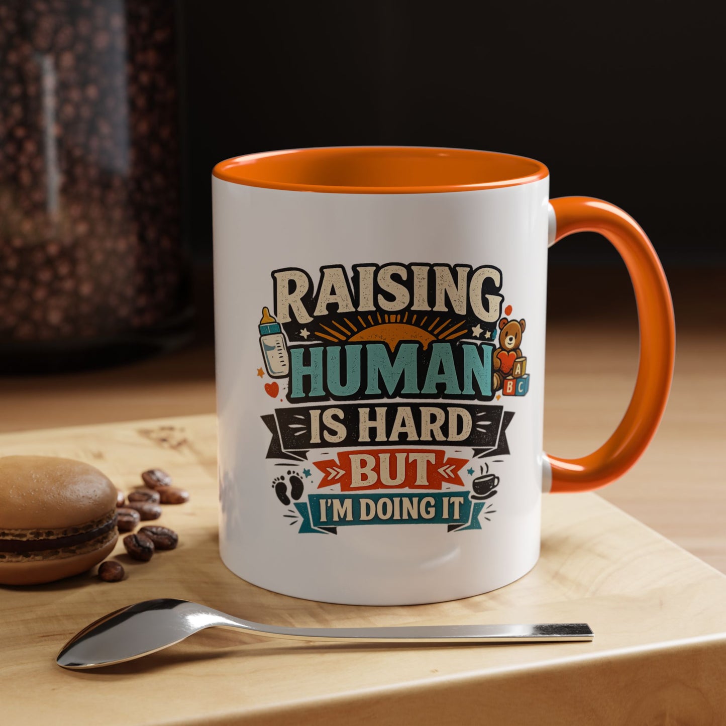 Accent Coffee Mug — "Raising Humans Is Hard But I'm Doing It"
