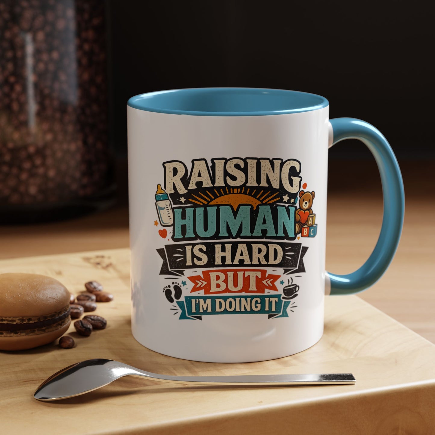 Accent Coffee Mug — "Raising Humans Is Hard But I'm Doing It"